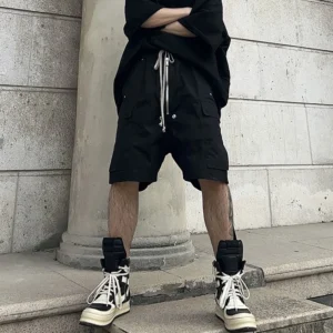 Men's black knee-length cargo pants with drawstring and multiple pockets.