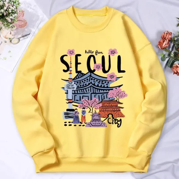 Woman wearing a warm casual hoodie with a colorful Seoul cityscape scenery print.