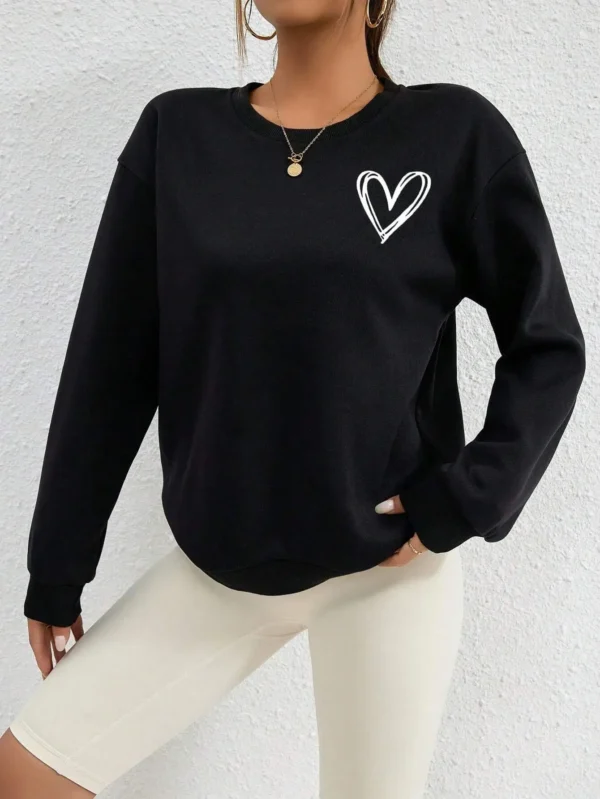 Women's casual crewneck sweatshirt with an all-over heart print pattern and soft fleece lining visible at the collar.