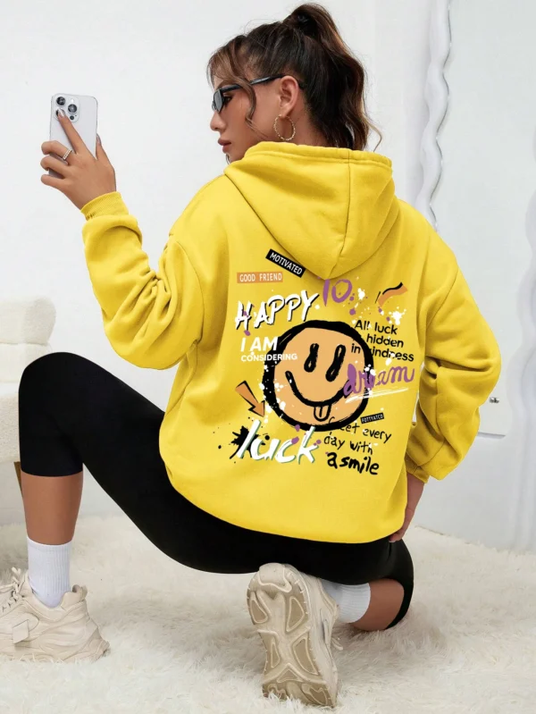 Woman wearing a casual fleece-lined hoodie with a colourful all-over graffiti street art print.
