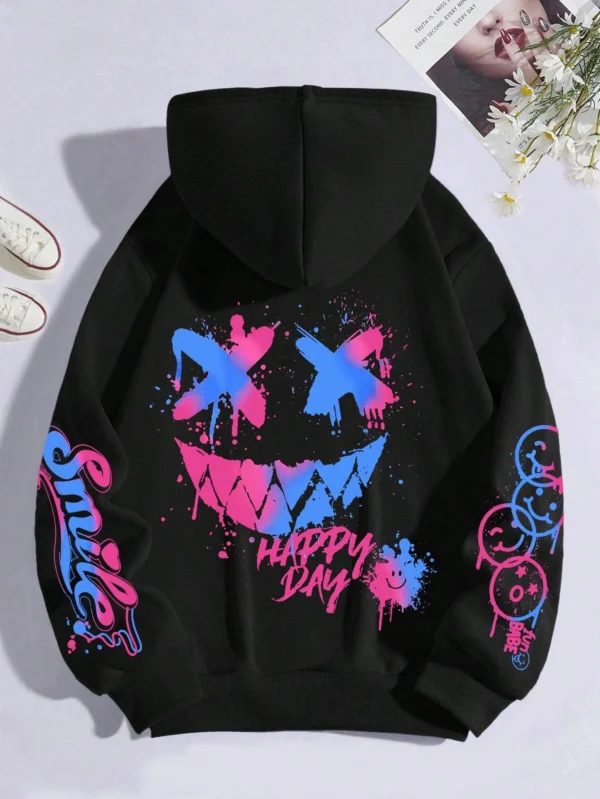 Front view of a woman wearing the oversized graffiti print hoodie