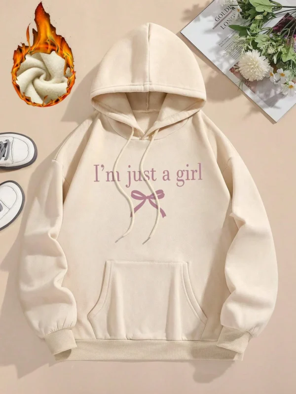 Woman wearing the warm fleece-lined 'I'm Just A Girl' pullover hoodie against a neutral background.