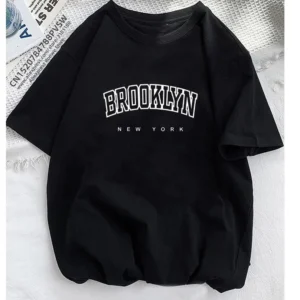 White short-sleeve t-shirt with large black 'Brooklyn' text graphic across the chest.