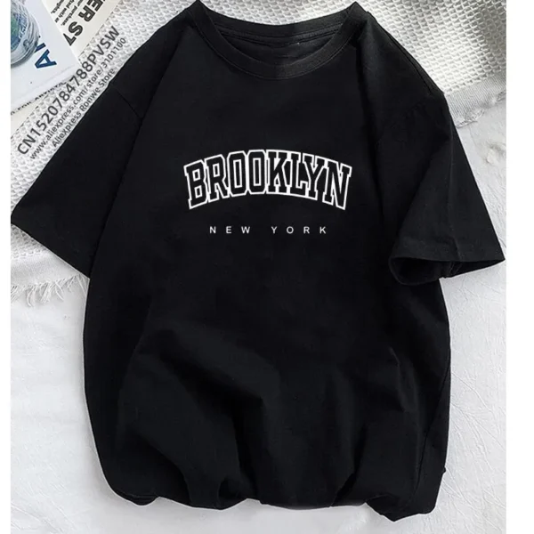 White short-sleeve t-shirt with large black 'Brooklyn' text graphic across the chest.