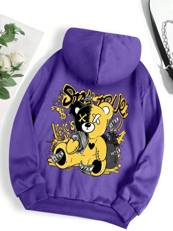Woman wearing oversized fleece hoodie with large bear cartoon print - Harajuku streetwear style.