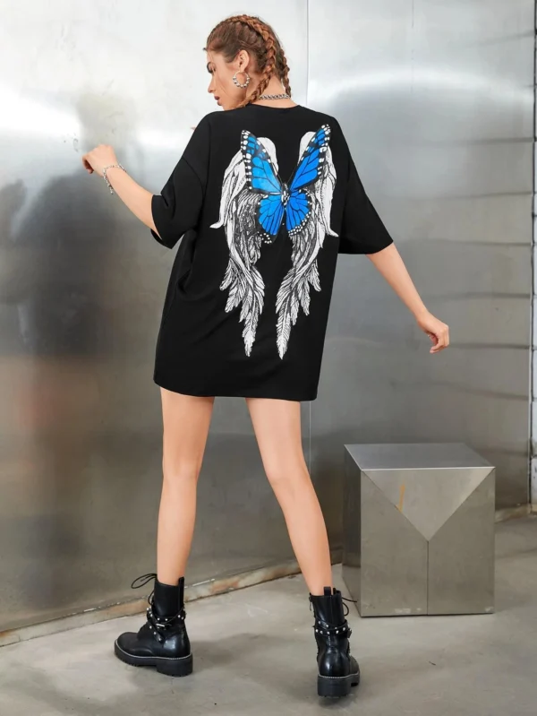 Woman wearing a white butterfly print t-shirt.