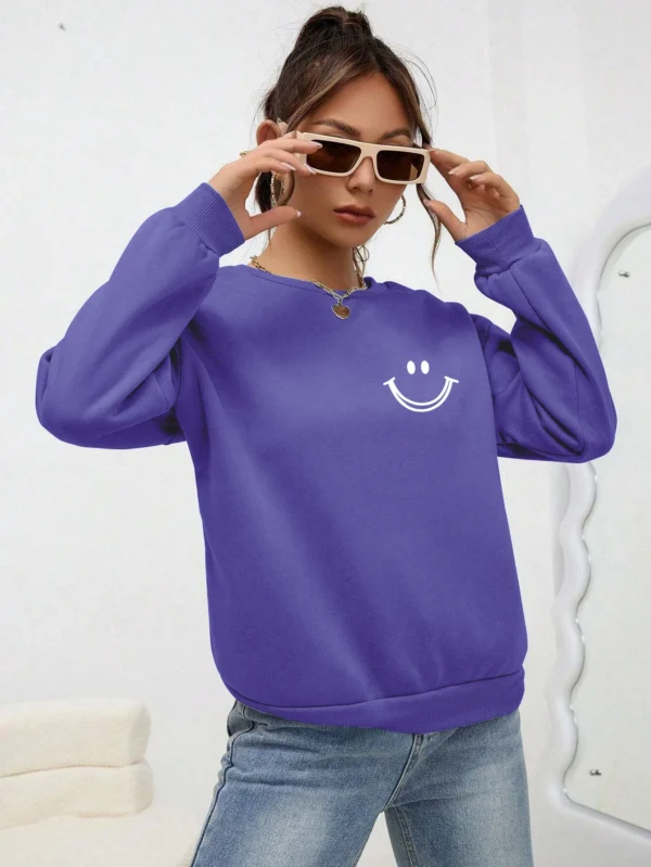 Women's O-neck fleece sweatshirt featuring a smiling face graphic print