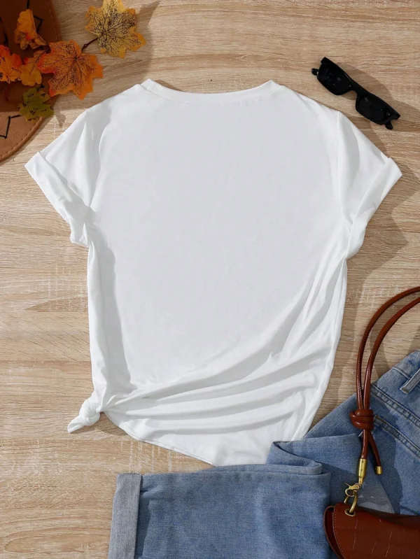 Woman wearing a casual white t-shirt with a blue and beige vintage seashell print.