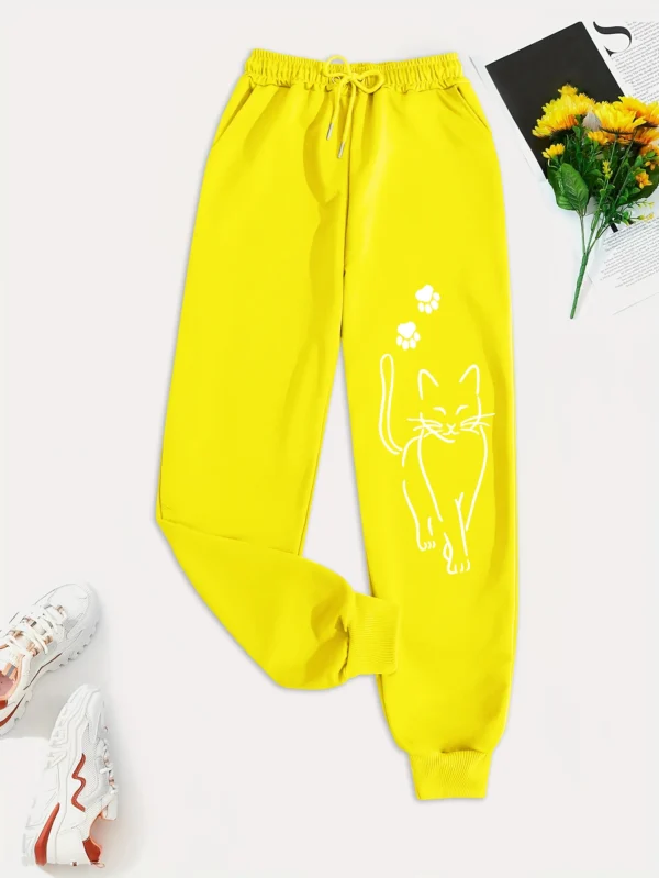 Woman wearing grey casual sweatpants with black cat print