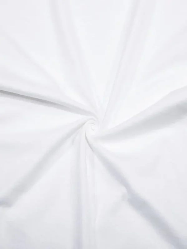 Woman wearing white oversized 'Balance' graphic print cotton t-shirt with loose fit and short sleeves.
