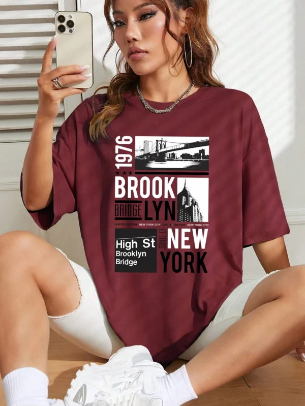 Woman wearing casual white t-shirt with retro "Brooklyn 1976 New York" graphic print.
