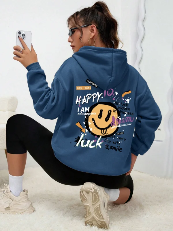 Woman wearing a casual fleece-lined hoodie with a colourful all-over graffiti street art print.