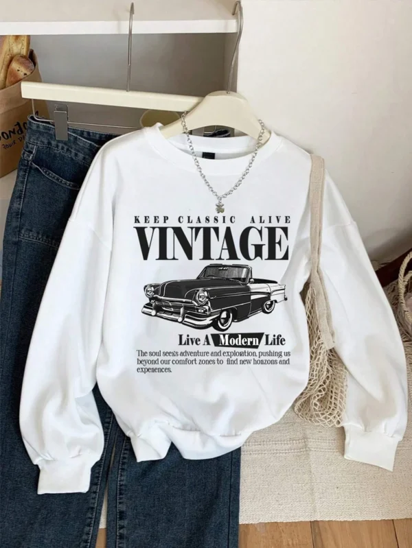 Woman wearing an oversized grey hoodie sweatshirt with a vintage car print