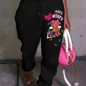Women's knit streetwear pants featuring a large cartoon bear graphic print on the leg - casual hip hop style.
