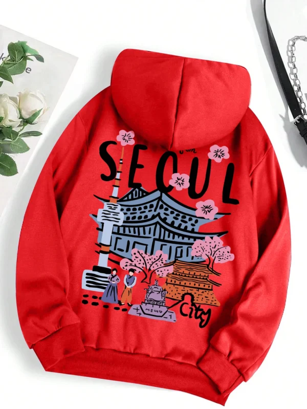 Woman wearing a comfortable warm fleece hoodie with a scenic Seoul print design and artificial fur lining visible inside the hood.