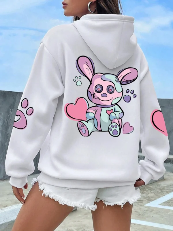 Woman wearing an oversized hoodie with a cute rabbit graphic print