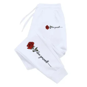 Women's casual sweatpants with pink rose print and 'Love Yourself' text on leg