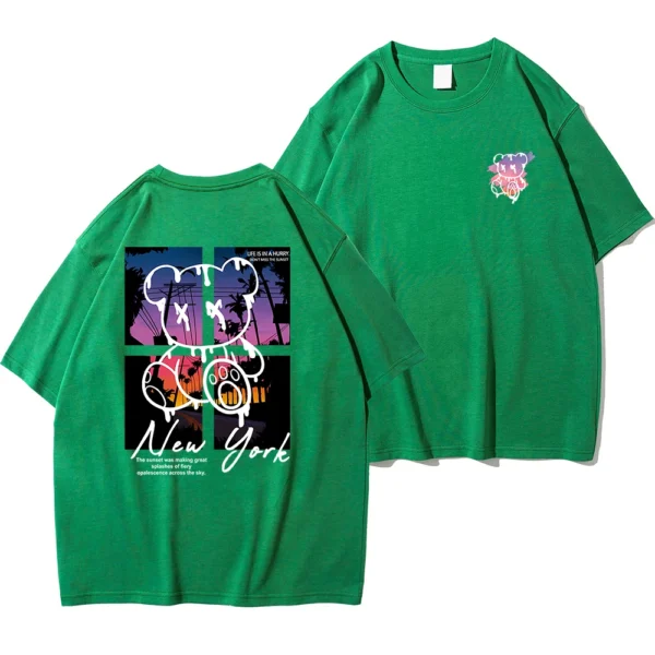 Men's loose fit cotton t-shirt displaying a colorful graphic print of a cartoon bear in front of a New York sunset scene.