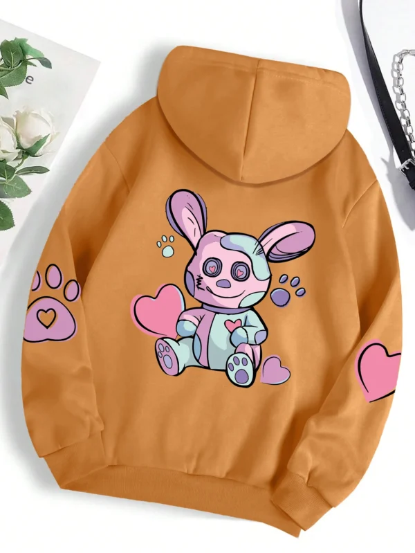 Woman wearing an oversized hoodie with a cute rabbit graphic print