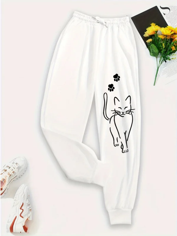 Woman wearing grey casual sweatpants with black cat print