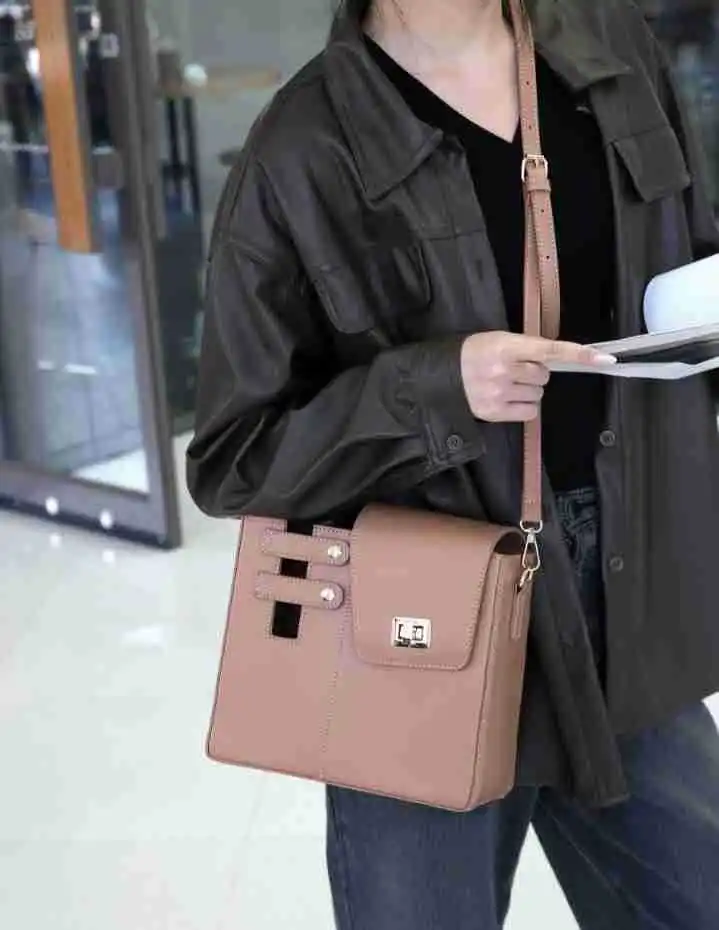 Protective tumbler carrier bag with adjustable strap holding a Stanley Quencher 40oz tumbler. Hands-free water bottle sleeve.