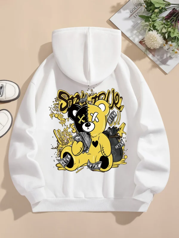 Woman wearing oversized fleece hoodie with large bear cartoon print - Harajuku streetwear style.