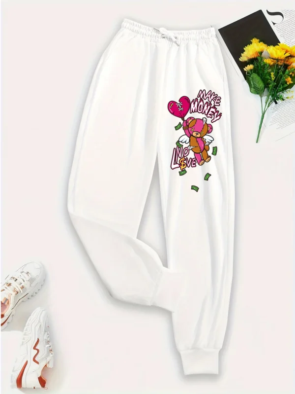 Women's knit streetwear pants featuring a large cartoon bear graphic print on the leg - casual hip hop style.