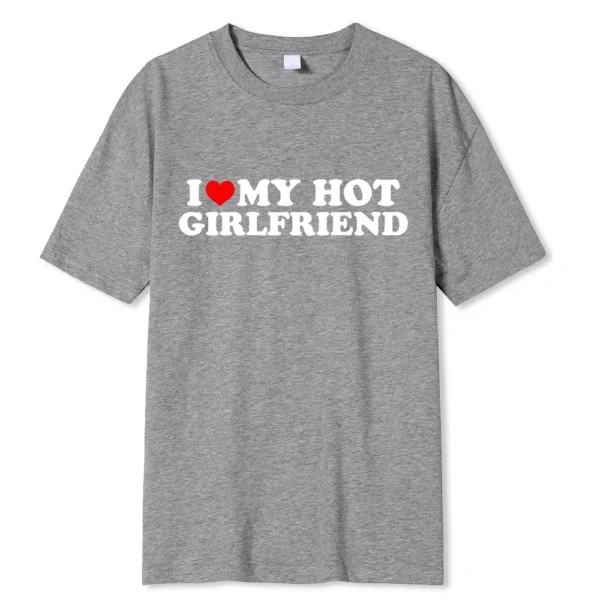 Person wearing funny black graphic tee with white 'I Love My Hot Girlfriend/Boyfriend' text print.