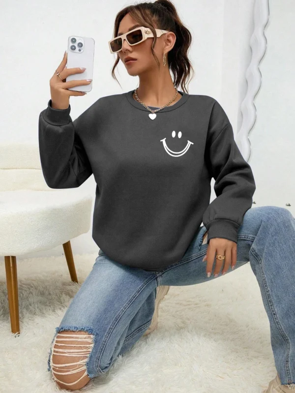 Women's O-neck fleece sweatshirt featuring a smiling face graphic print