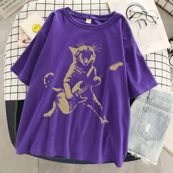 Woman wearing a funny cat playing guitar t-shirt.