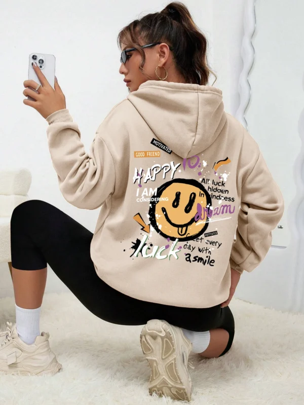 Woman wearing a casual fleece-lined hoodie with a colourful all-over graffiti street art print.