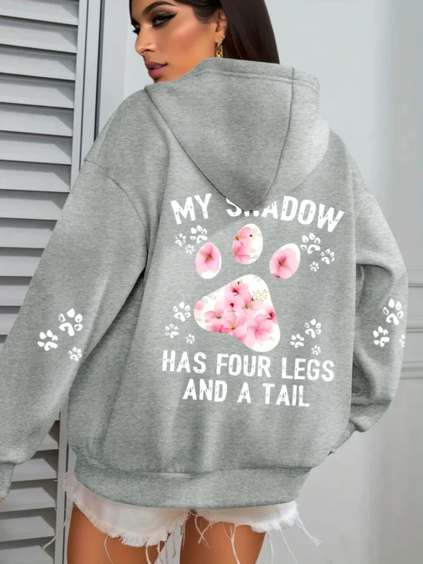Woman wearing a "My Shadow Has Four Legs" fleece hoodie.