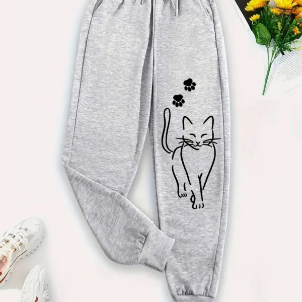 Woman wearing grey casual sweatpants with black cat print