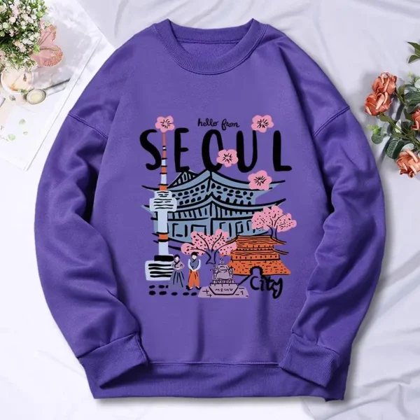 Woman wearing a warm casual hoodie with a colorful Seoul cityscape scenery print.