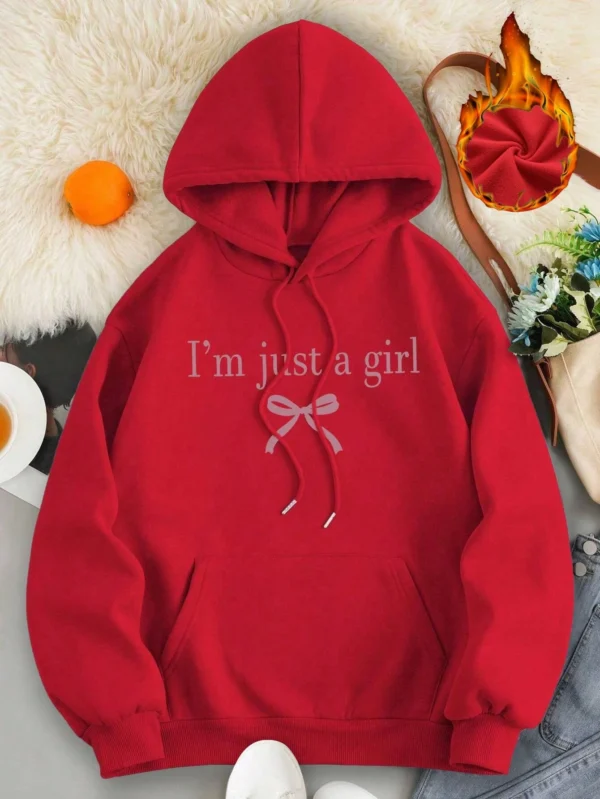 Woman wearing the warm fleece-lined 'I'm Just A Girl' pullover hoodie against a neutral background.