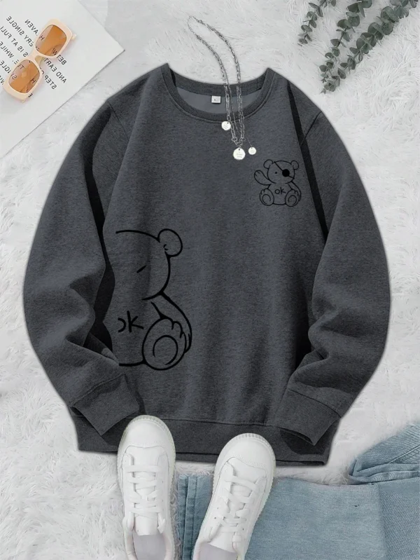 Women's retro beige fleece hoodie with a cute Kawaii teddy bear 'OK' print graphic on the front.