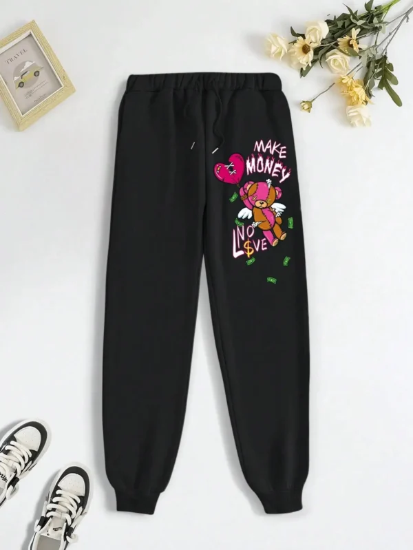 Women's knit streetwear pants featuring a large cartoon bear graphic print on the leg - casual hip hop style.