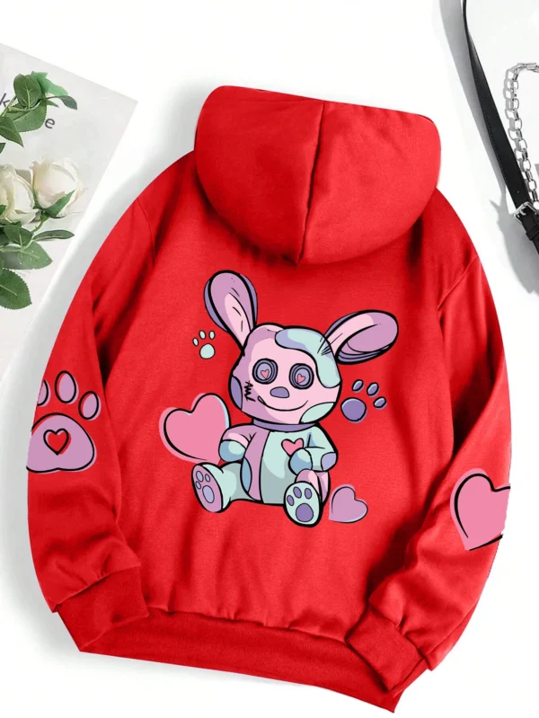 Woman wearing an oversized hoodie with a cute rabbit graphic print