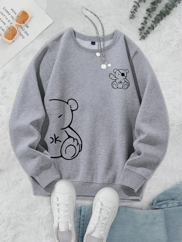 Women's retro beige fleece hoodie with a cute Kawaii teddy bear 'OK' print graphic on the front.