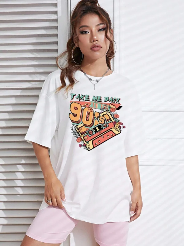 Woman wearing a soft white t-shirt with a colorful retro 'Take Me Back 90s' graphic print.