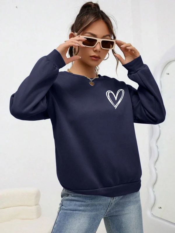 Women's casual crewneck sweatshirt with an all-over heart print pattern and soft fleece lining visible at the collar.