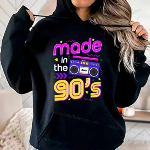 Woman wearing a vibrant neon hoodie with 'Take Me Back To The 90's' graphic print
