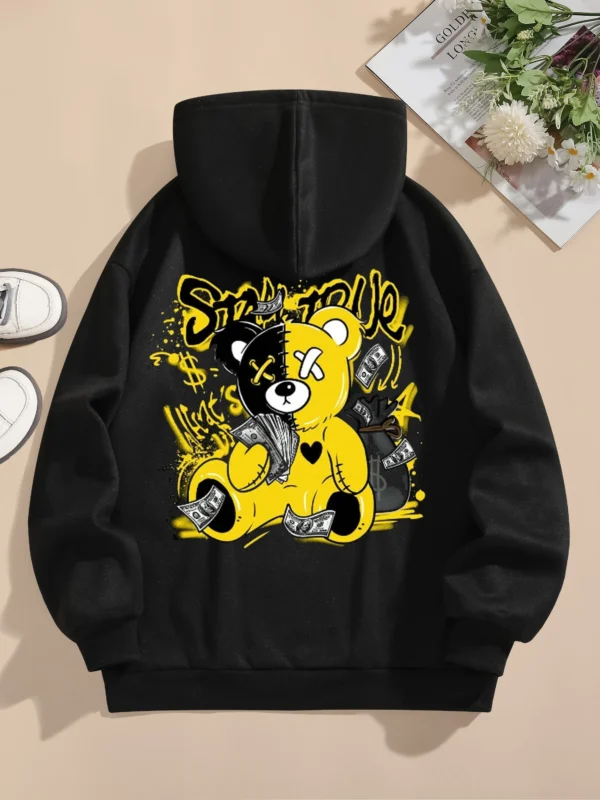 Woman wearing oversized fleece hoodie with large bear cartoon print - Harajuku streetwear style.