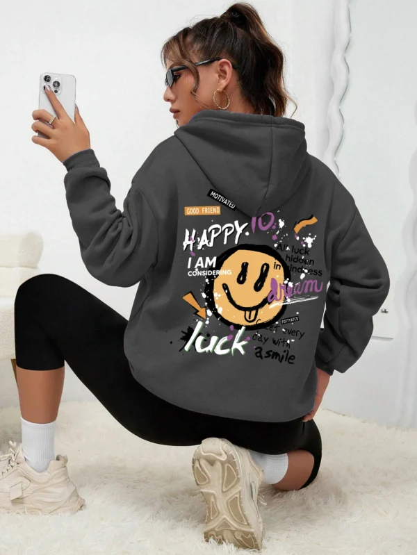 Woman wearing a casual fleece-lined hoodie with a colourful all-over graffiti street art print.