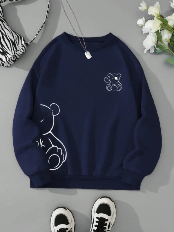 Women's retro beige fleece hoodie with a cute Kawaii teddy bear 'OK' print graphic on the front.