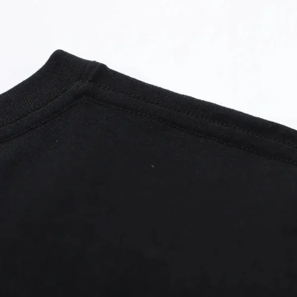 Back view of man wearing black GTR R34 JDM graphic t-shirt showcasing Japanese car culture design.