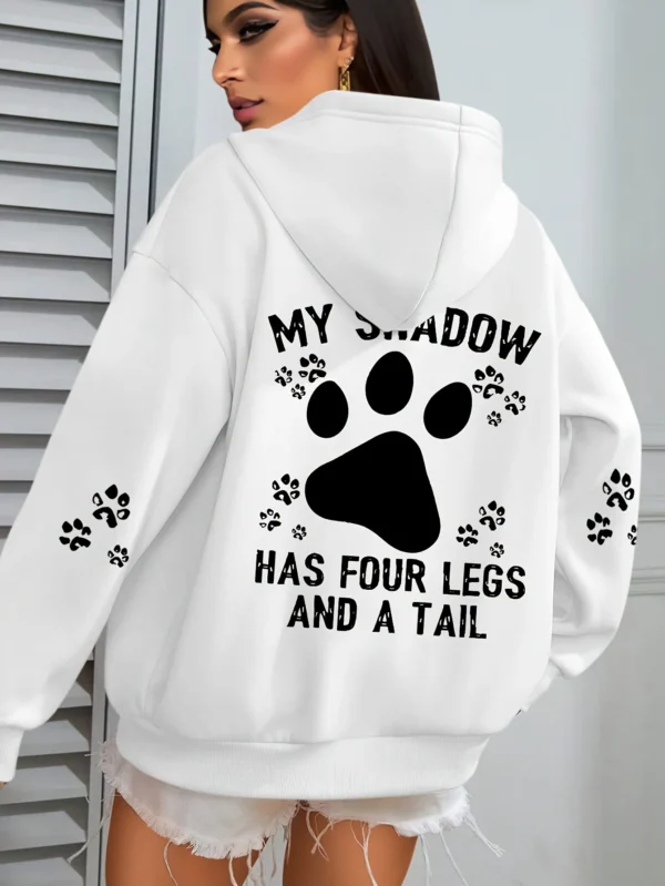 Woman wearing a "My Shadow Has Four Legs" fleece hoodie.