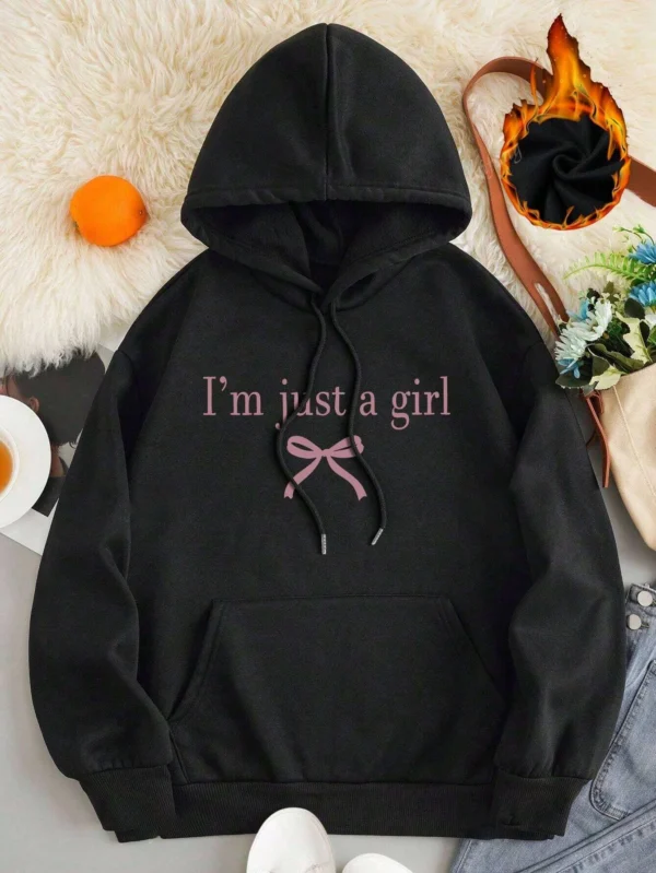 Woman wearing the warm fleece-lined 'I'm Just A Girl' pullover hoodie against a neutral background.