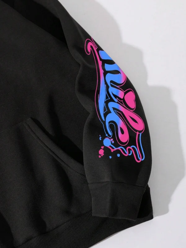Front view of a woman wearing the oversized graffiti print hoodie