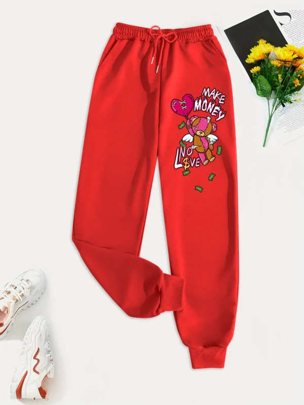 Women's knit streetwear pants featuring a large cartoon bear graphic print on the leg - casual hip hop style.